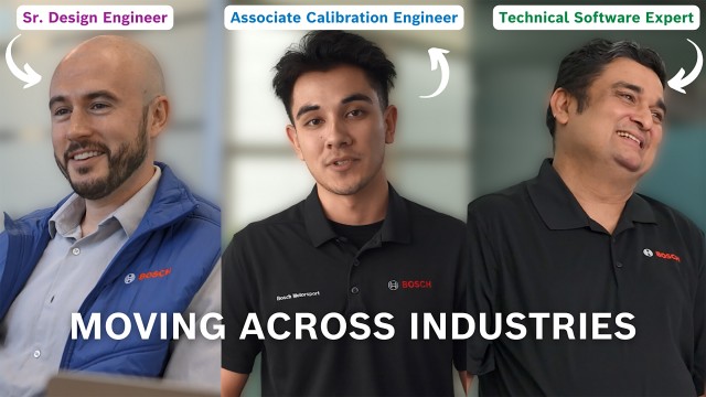 A woman sits in a homework environment and smiles at the camera.