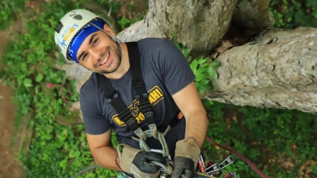 Dillon Kesto climbing a tree