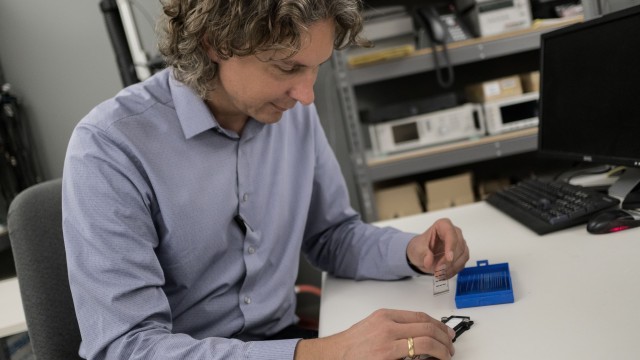 man examining microscope slides