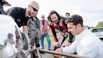 A Group of people standing by a motorcycle