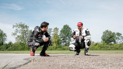 People crouching on the street in motorcycle gear