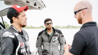 People discussing near a car