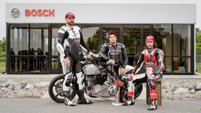 ARCH group picture with a motorcycle in front of Bosch