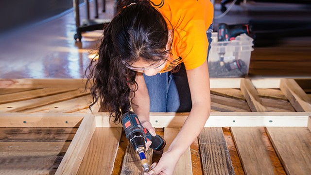 Girl working with a power tool