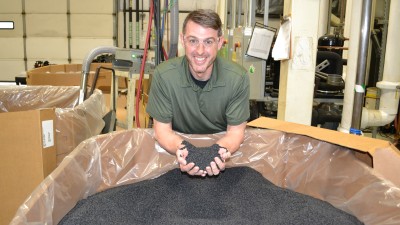 Mike Kugler holding pellets in bin