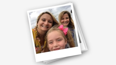 A polaroid of Nicole Huard, her mother and daughter laying on a white backgroung.