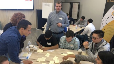 Associates working together at BHive Hackathon.